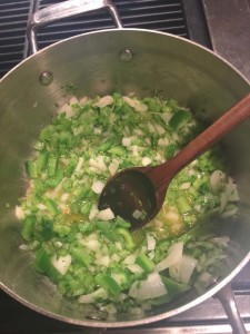 Onions, celery, and green bell peppers into the garlic infused olive oil