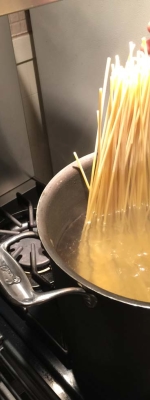 The pasta is placed in the salty boiling water